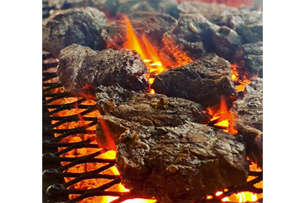 Photo of steaks on a grill from Exquisite Catering